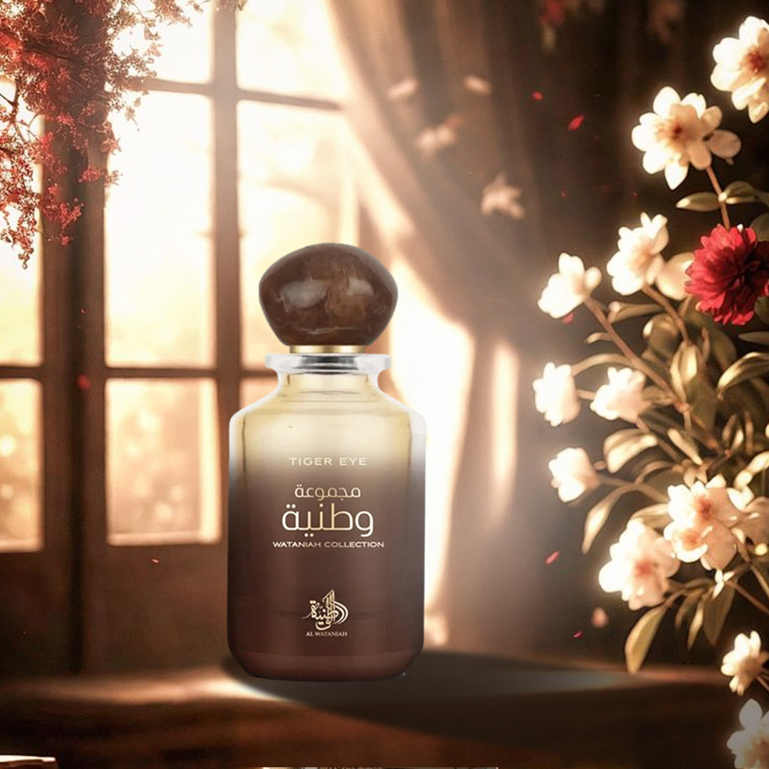 Perfume bottle with floral arrangement and window in the background