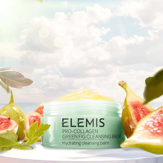 Elemis Pro-Collagen Green Fig Cleansing Balm 100g in a picturesque setting with fresh figs and foliage around.